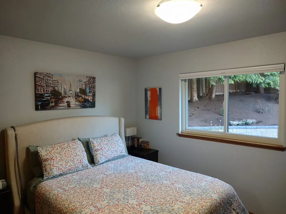 Bedroom with freshly painted soft gray walls and white trim