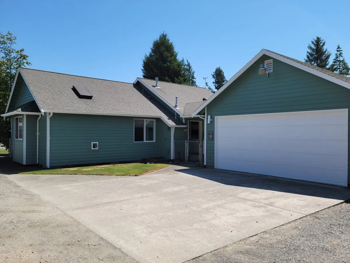 Teal house and detached garage, repainted by our crew